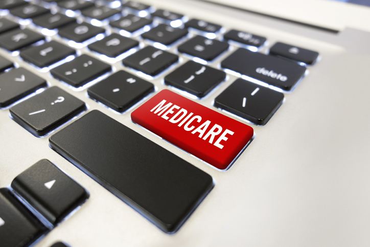 Red Medicare button on a keyboard to illustrate Medicare conditional payment.