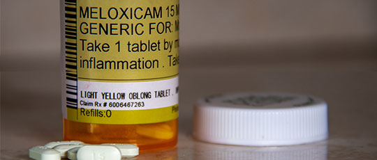 Prescription drug bottle to illustrate Meloxican's price drop