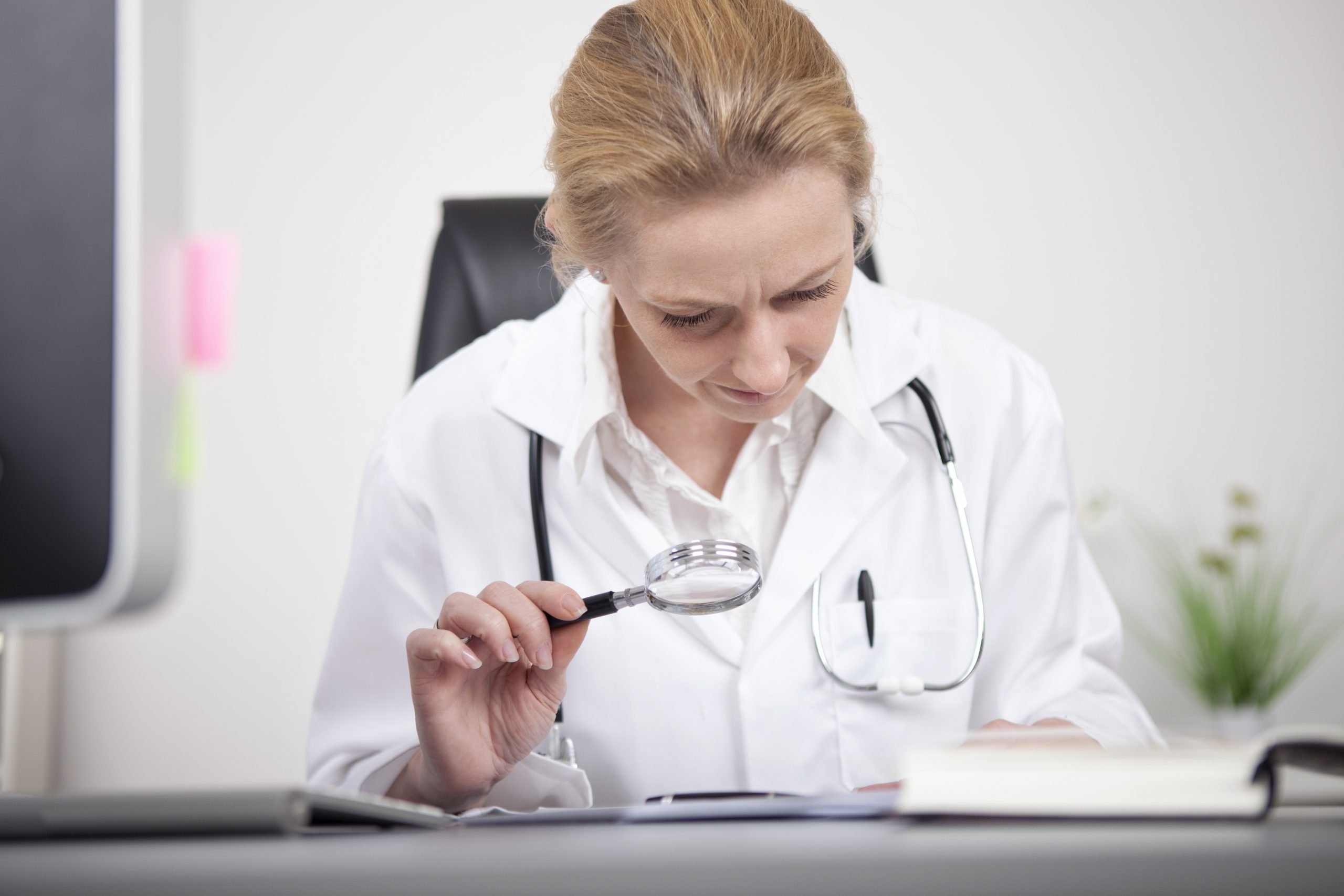 nurse conducting research for a Medicare Set Aside Second Opinion in a manual