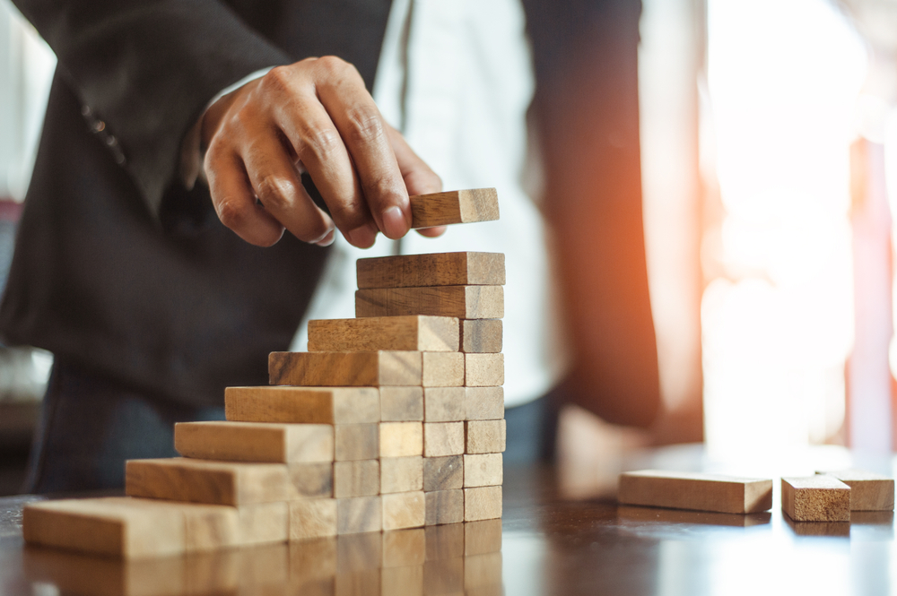 Man with blocks is building a tower