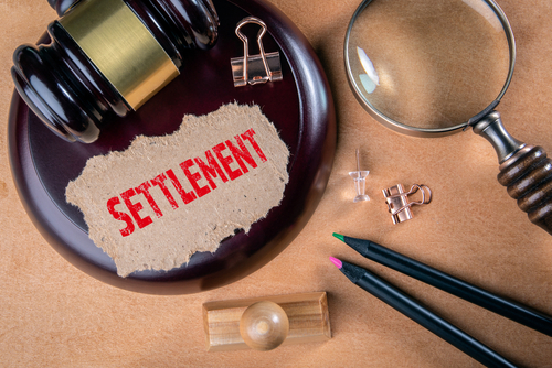 a gavel and a magnifying glass to represent Medicare Set Aside settlement process
