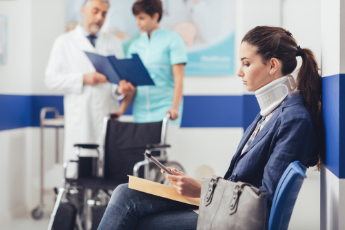 woman sitting in a dr waiting room to discuss her liability case