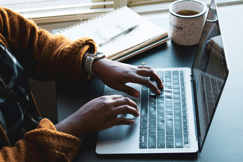 remote employee working on a laptop taking all the right cybersecurity measures